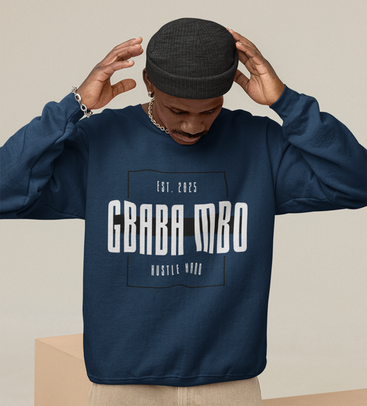 Person wearing a navy blue sweatshirt with text, standing on beige geometric blocks.