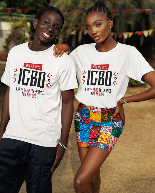 Two people wearing white t-shirts with 'IGBO' text, standing outdoors with a colorful background.