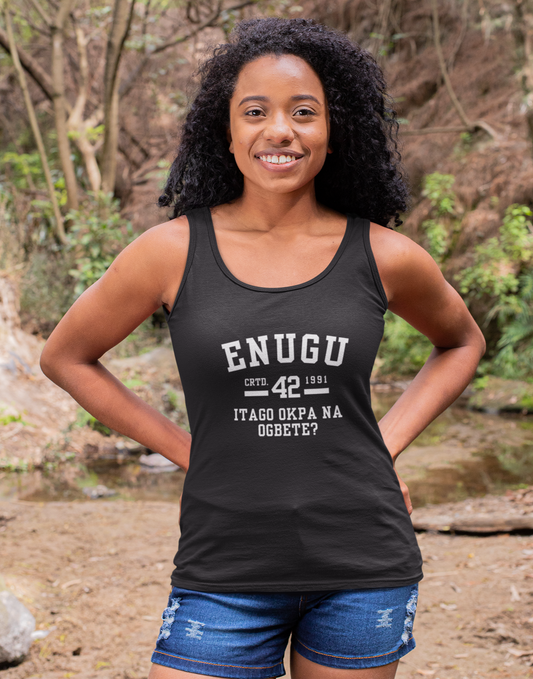 Woman wearing a black tank top with text standing in a forest setting